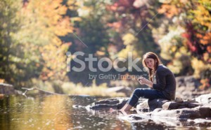 stock-photo-52495128-teenager-girl-sits-on-the-rock-at-the-river